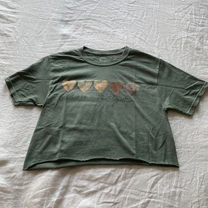 Small, green crop-top made by the brand social culture